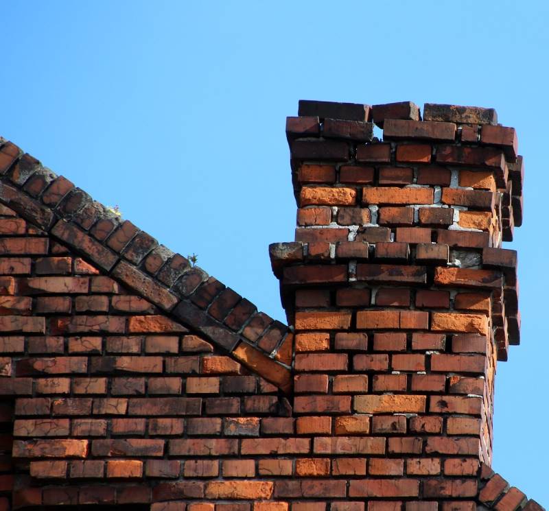 Signs Your Hialeah Home Needs a Chimney Inspection Damaged chimney on an Hialeah home showing cracks and missing mortar